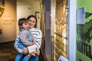 Woman and child looking at display case