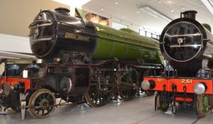 Photograph of two green locomotives