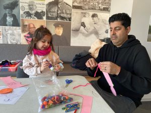 Man and a child crafting in our Museum space.