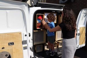 A parent and child handling an exhibition item.
