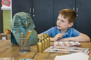 young boy looking at a bust of Tutankhamun