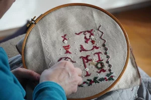 woman doing cross stitch