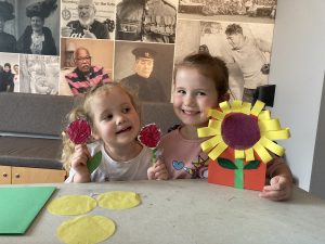 Two children with sunflower crafts